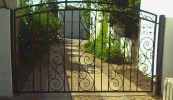 arched single swing gate with big S and small S scrolls