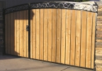 arched decorative RV gate with black steel and light cedar wood